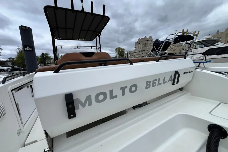 Slide: The Image of 2020 Beneteau Flyer 8 SPACEdeck boat named "Molto Bella" docked under cloudy skies. - 9