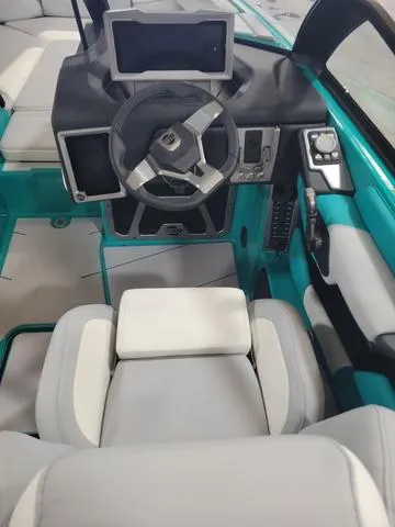 Slide: The Image of 2023 Malibu M220 boat interior with modern dashboard and steering wheel. - 5