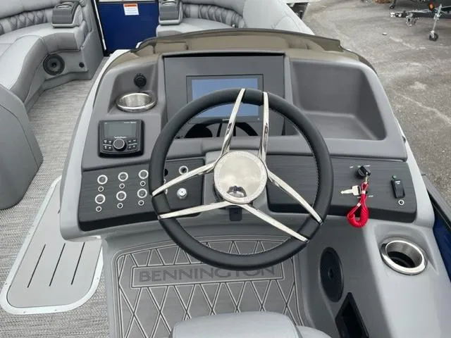 Slide: The Image of 2023 Bennington 23R boat dashboard with steering wheel and control panel. - 10