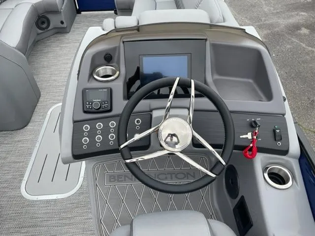 Slide: The Image of 2023 Bennington 23R boat dashboard with steering wheel and control panel. - 11
