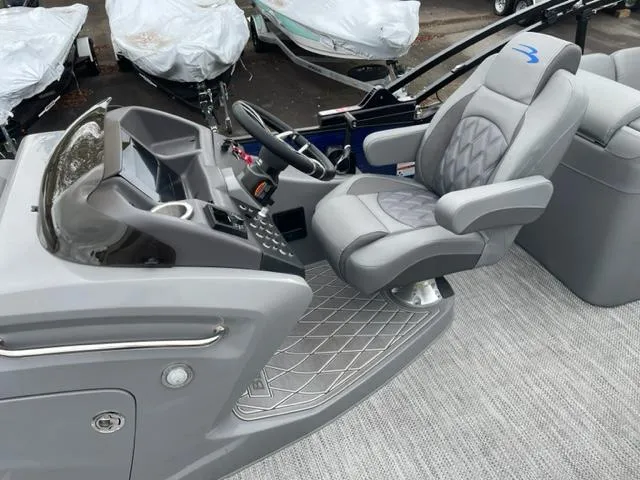 Slide: The Image of 2023 Bennington 23R boat interior with modern helm and comfortable seating. - 9