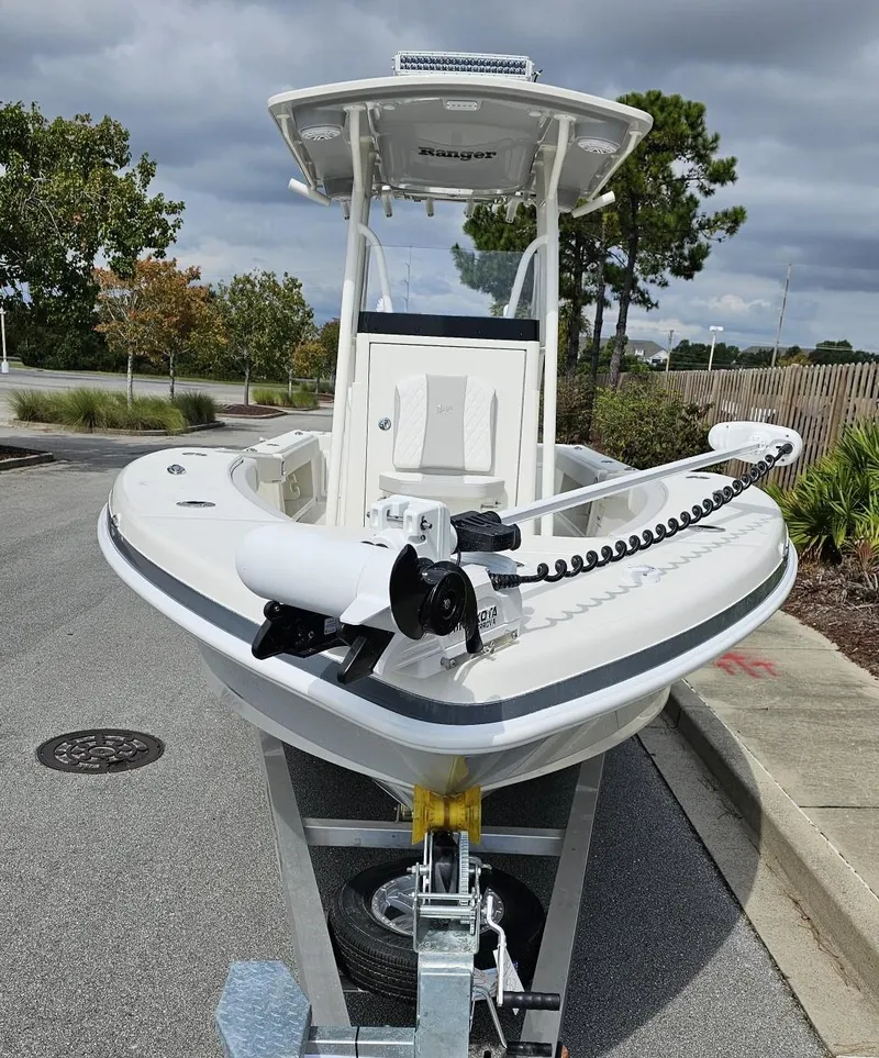 Slide: The Image of 2024 Ranger 2600 Bay boat on trailer, front view, outdoors. - 11