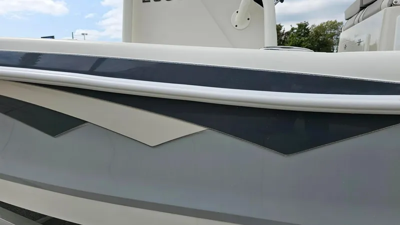 Slide: The Image of 2024 Ranger 2600 Bay boat side view with sleek design and modern graphics. - 17