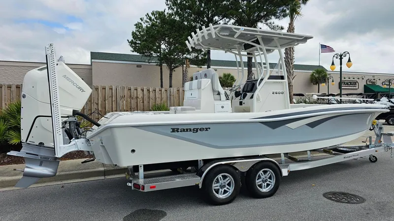 Slide: The Image of 2024 Ranger 2600 Bay boat on a trailer, side view. - 31