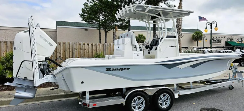 Slide: The Image of 2024 Ranger 2600 Bay boat on trailer, side view. - 8