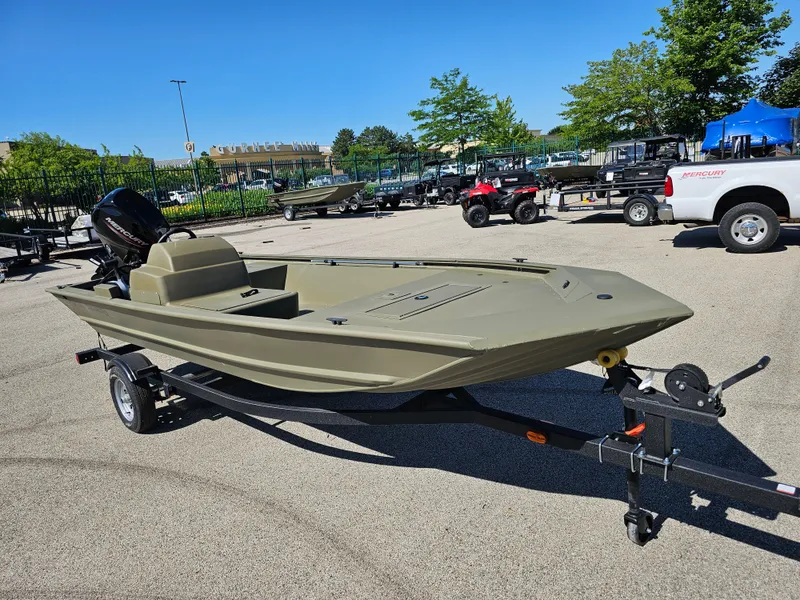 Slide: The Image of 2024 Tracker Grizzly 1648 SC boat on a trailer in a parking lot. - 2