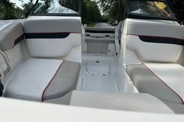 Slide: The Image of 2024 Tahoe 185 S boat interior with gray and white seating, red accents. - 12