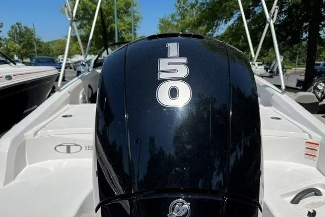 Slide: The Image of 2024 Tahoe 185 S boat with a 150 horsepower engine, parked outdoors. - 4
