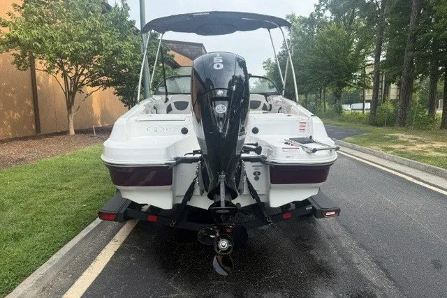 Slide: The Image of 2024 Tahoe 185 S boat with outboard motor, parked on a paved road. - 3
