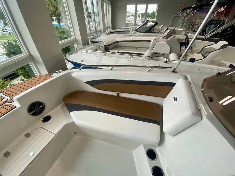 Slide: The Image of 2026 Starcraft SVX 171 boat interior with sleek seating and modern design in showroom. - 17