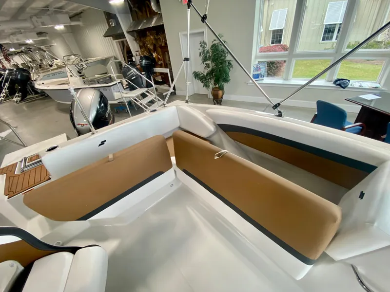 Slide: The Image of 2026 Starcraft SVX 171 boat interior with tan seating in showroom. - 6