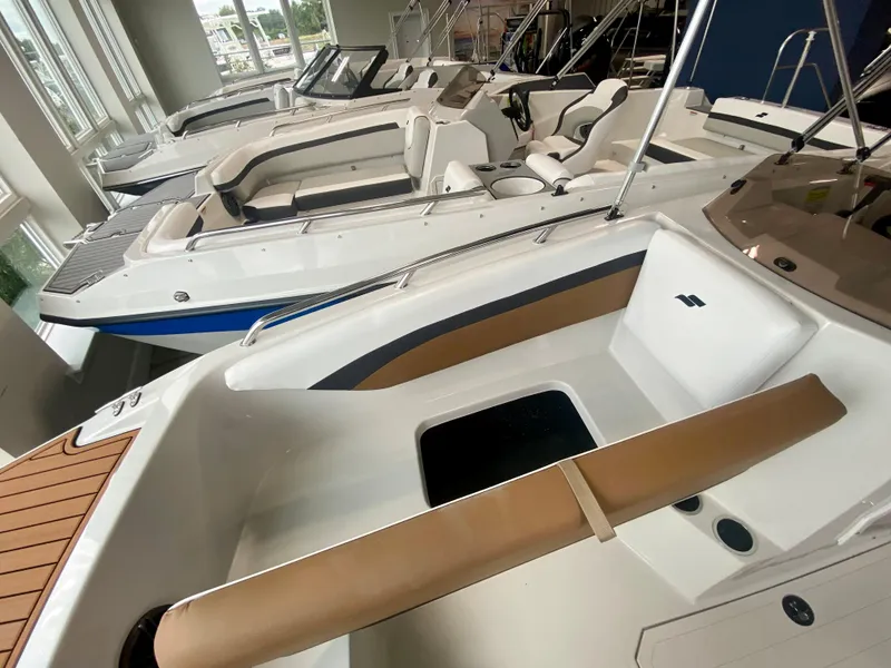 Slide: The Image of 2026 Starcraft SVX 171 boat interior with seating, displayed in a showroom. - 18