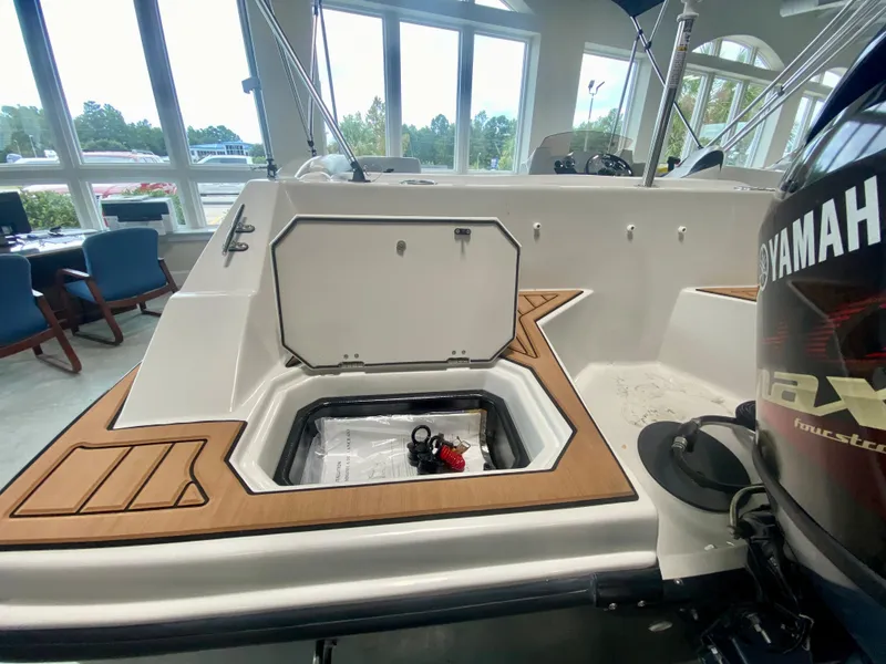 Slide: The Image of 2026 Starcraft SVX 171 boat interior with storage compartment and Yamaha engine. - 3