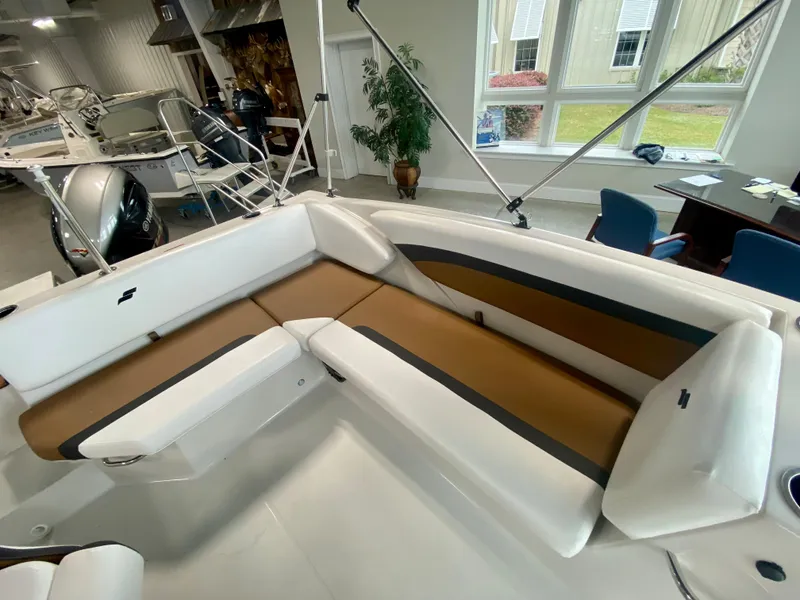 Slide: The Image of 2026 Starcraft SVX 171 boat interior with white and brown seating in showroom. - 5