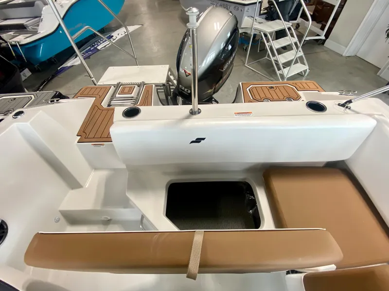 Slide: The Image of 2026 Starcraft SVX 171 boat interior with tan seating and motor, showcasing modern design. - 7