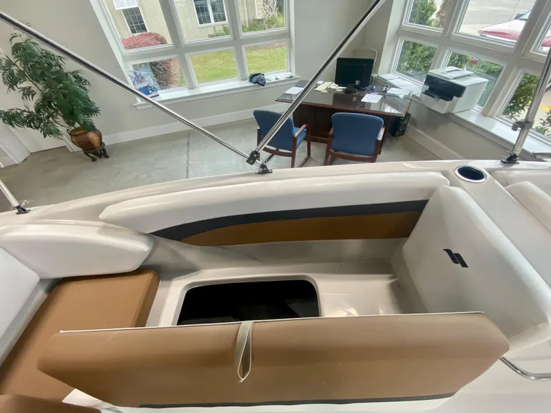 Slide: The Image of 2026 Starcraft SVX 171 boat interior with seating and storage, displayed indoors. - 8
