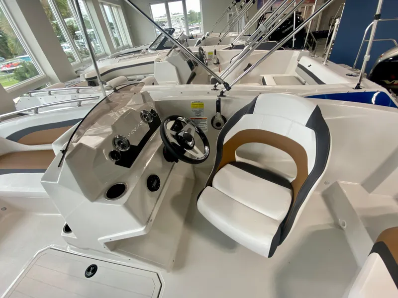 Slide: The Image of 2026 Starcraft SVX 171 boat interior with modern steering console and comfortable seating. - 9