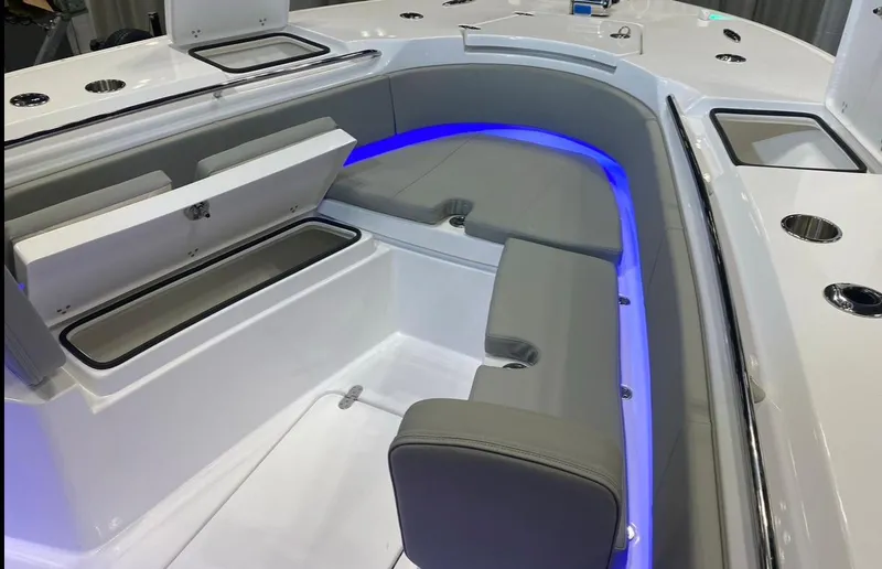 Slide: The Image of 2025 Cape Horn Yachts 32 XS interior with gray seating and blue LED lighting. - 16