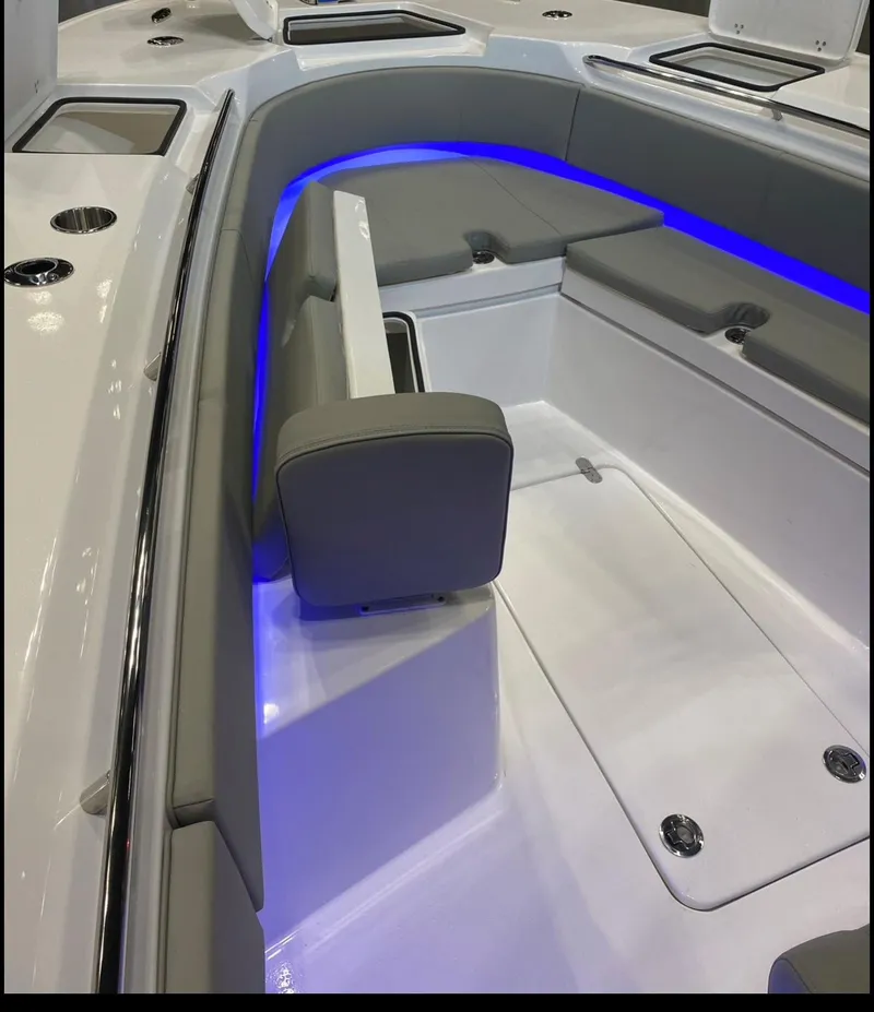 Slide: The Image of 2025 Cape Horn Yachts 32 XS interior with sleek seating and blue LED lighting. - 17