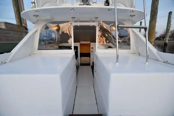 Slide: The Image of 1965 Bertram Sportfisher boat interior with sleek white design and spacious layout. - 14