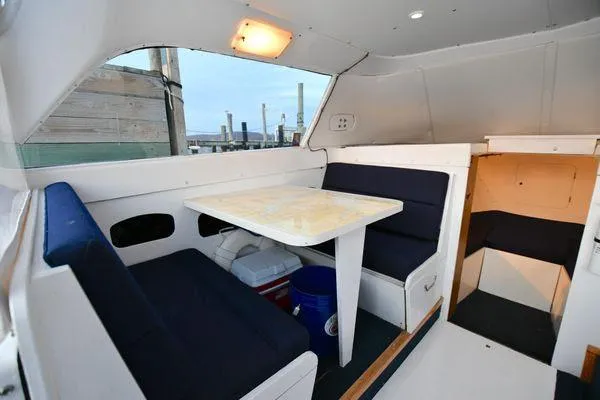 Slide: The Image of Interior of a 1965 Bertram Sportfisher boat with a cozy dining area. - 16