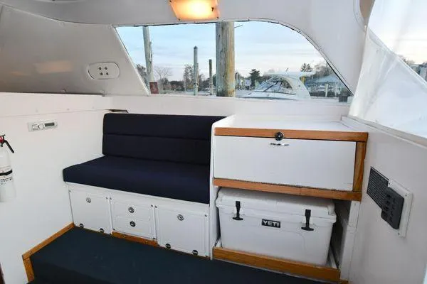 Slide: The Image of 1965 Bertram Sportfisher interior with seating, storage, and Yeti cooler. - 17