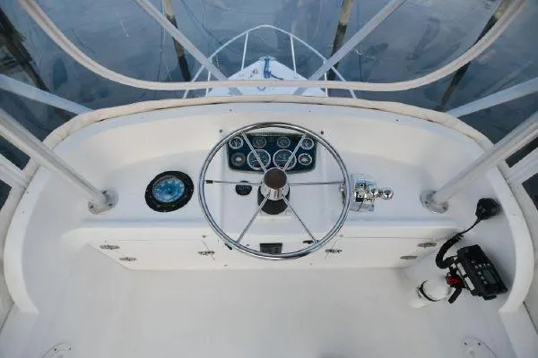 Slide: The Image of 1965 Bertram Sportfisher helm with steering wheel and navigation instruments. - 25