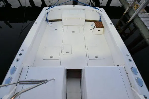 Slide: The Image of 1965 Bertram Sportfisher boat deck, spacious and well-maintained, docked at marina. - 26