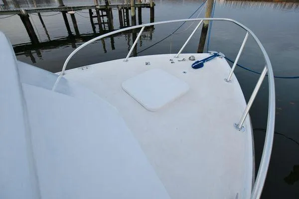 Slide: The Image of 1965 Bertram Sportfisher boat deck with railing and dock view. - 31