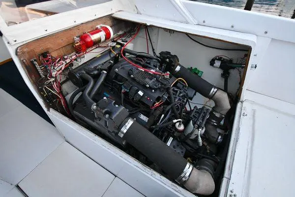 Slide: The Image of 1965 Bertram Sportfisher engine compartment with visible wiring and fire extinguisher. - 34