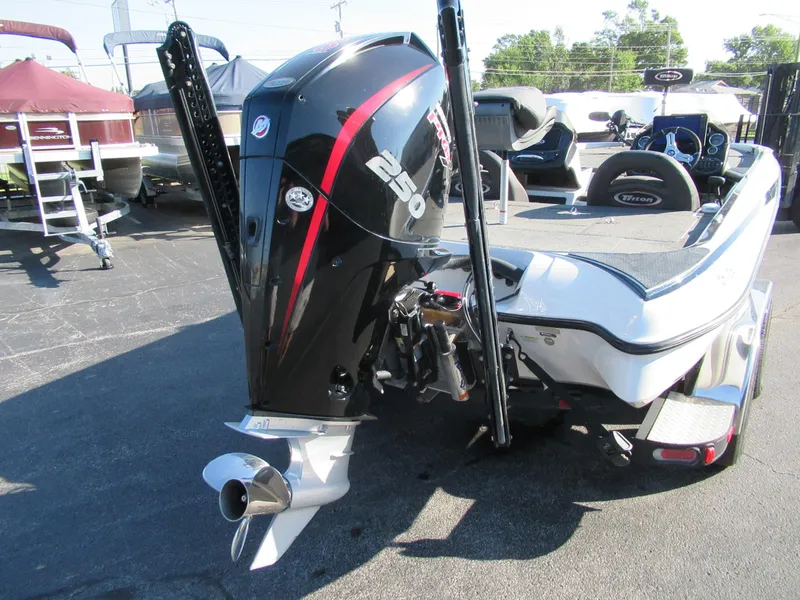 Slide: The Image of 2019 Triton 21 TrX Elite boat with powerful outboard motor, parked outdoors. - 5