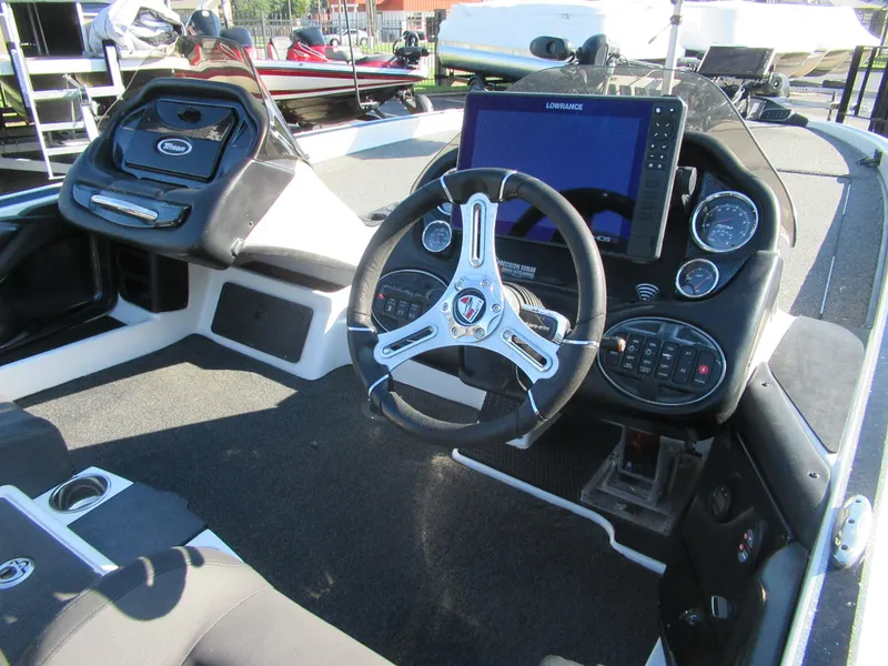 Slide: The Image of 2019 Triton 21 TrX Elite boat cockpit with steering wheel and navigation system. - 6