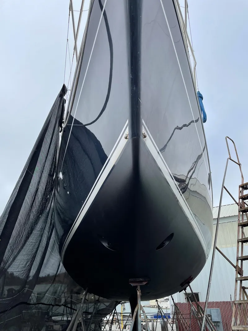 Slide: The Image of Jeanneau 52.2 sailboat from 2000, docked and viewed from the bow. - 14