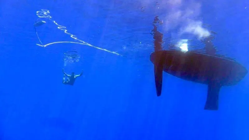 Slide: The Image of Underwater view of a 2000 Jeanneau 52.2 sailboat hull in clear blue water. - 22