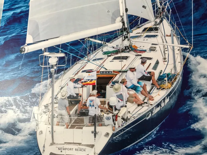 Slide: The Image of Sailing yacht Jeanneau 52.2, 2000 model, cruising on open ocean with crew onboard. - 25