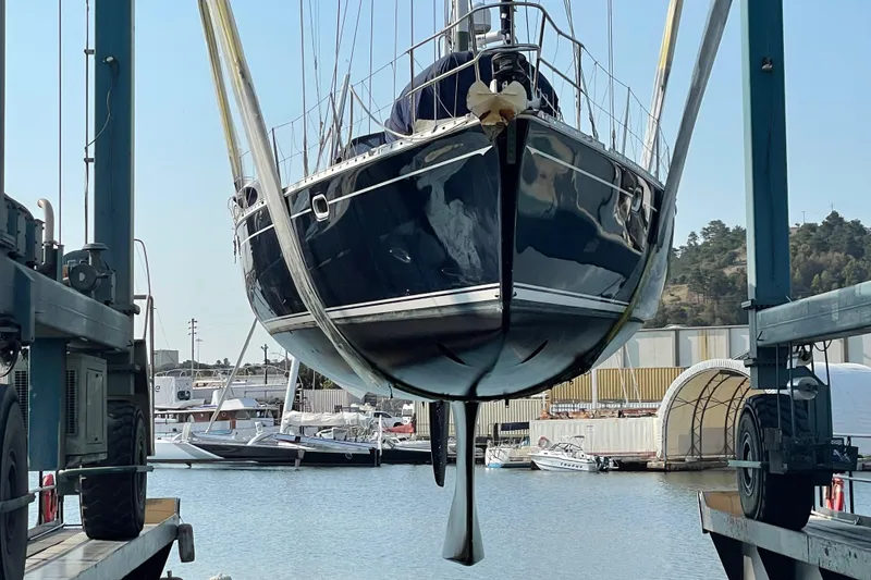 Slide: The Image of Jeanneau 52.2 sailboat from 2000 being lifted at a marina. - 27