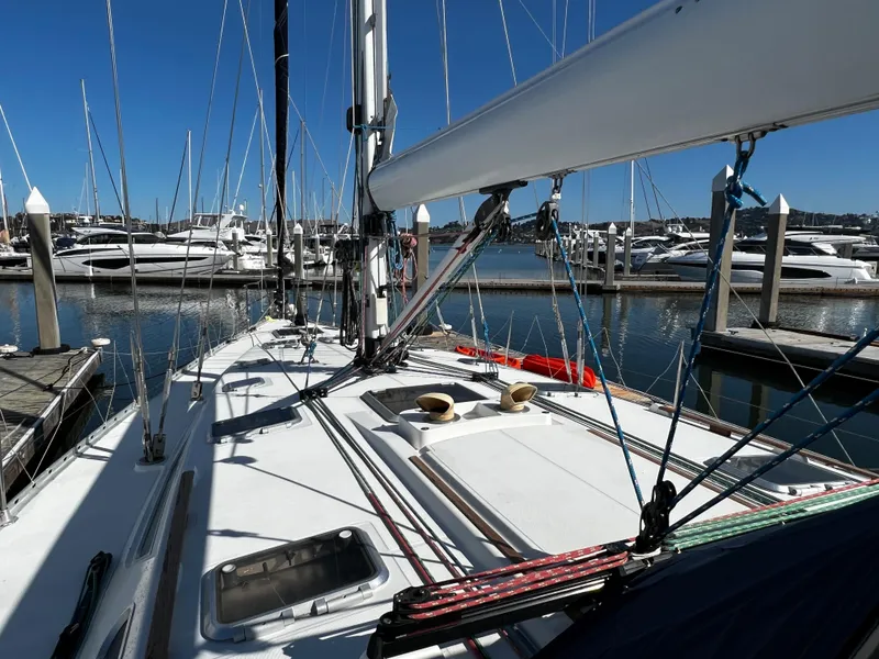 Slide: The Image of Sailboat Jeanneau 52.2, 2000 model, docked in marina with clear blue sky. - 29
