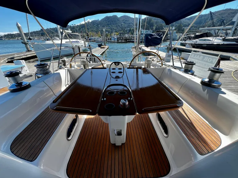 Slide: The Image of Cockpit of 2000 Jeanneau 52.2 sailboat with wooden table and dual steering wheels. - 32