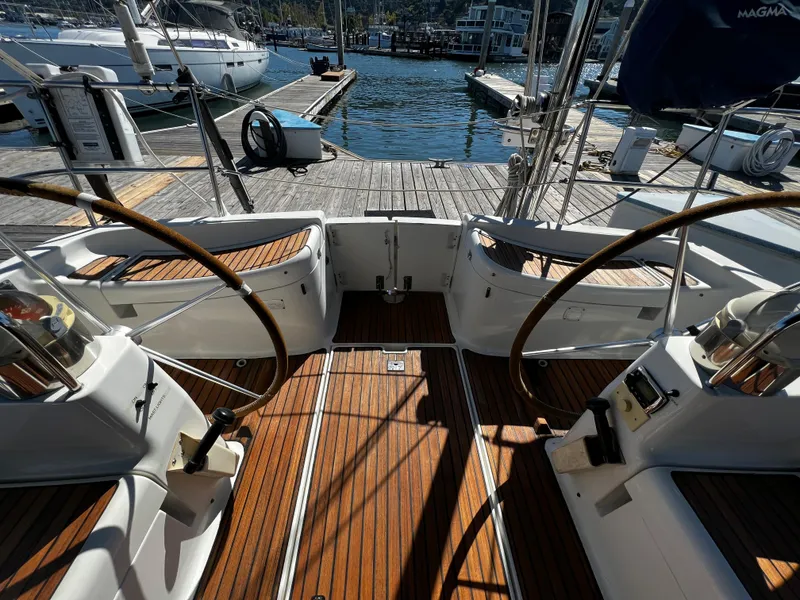Slide: The Image of Cockpit view of 2000 Jeanneau 52.2 sailboat with dual steering wheels at marina. - 35