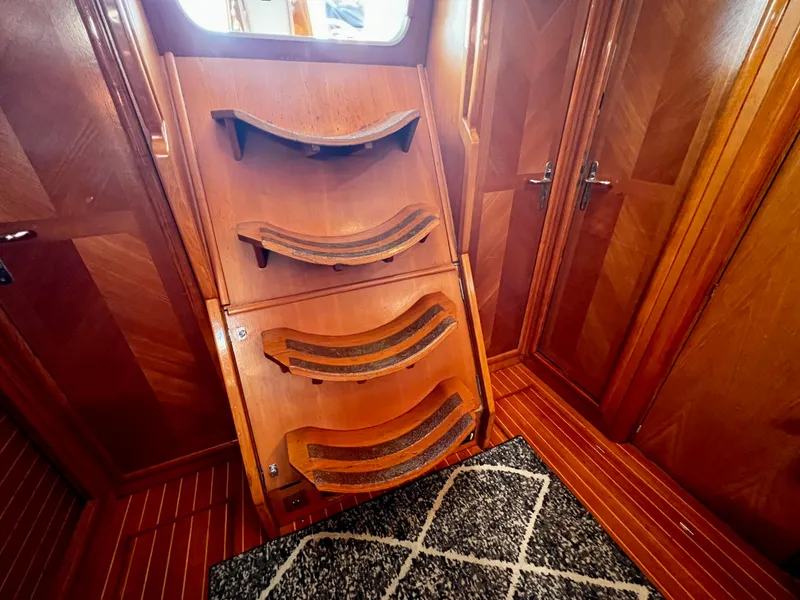 Slide: The Image of Interior of 2000 Jeanneau 52.2 yacht with wooden stairs and patterned rug. - 39