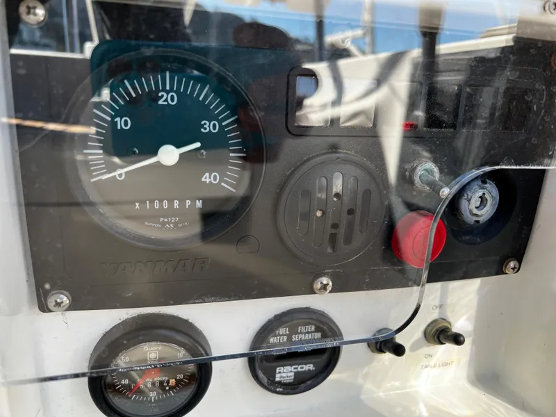 Slide: The Image of Control panel of a 2000 Jeanneau 52.2 sailboat, featuring RPM gauge and switches. - 40