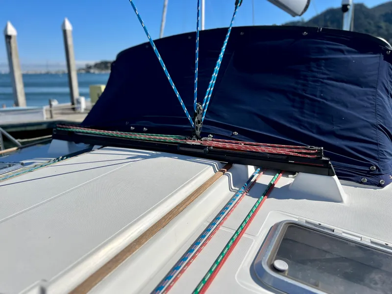 Slide: The Image of Jeanneau 52.2 sailboat deck, 2000 model, with colorful rigging and blue cover. - 46