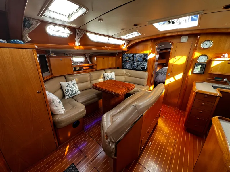 Slide: The Image of Luxurious interior of a 2000 Jeanneau 52.2 yacht with elegant wood finishes. - 48
