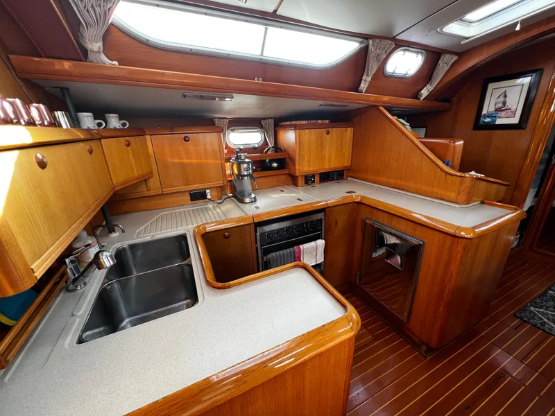 Slide: The Image of Spacious kitchen in 2000 Jeanneau 52.2 yacht with wooden cabinetry and modern appliances. - 49