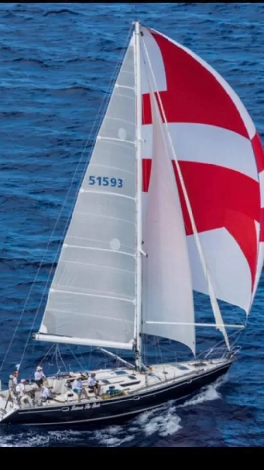 Slide: The Image of Sailing yacht Jeanneau 52.2 (2000) with red and white spinnaker on open sea. - 5