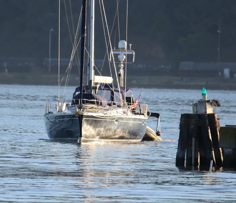 Slide: The Image of Sailing yacht Jeanneau 52.2, 2000 model, navigating near a wooden pier. - 7