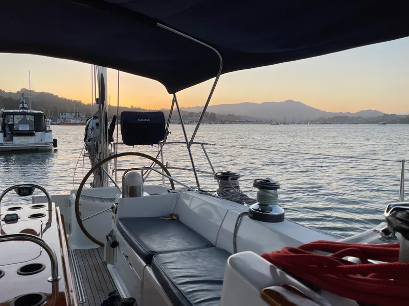 Slide: The Image of Jeanneau 52.2 sailboat interior at sunset, 2000 model, serene waterfront view. - 9