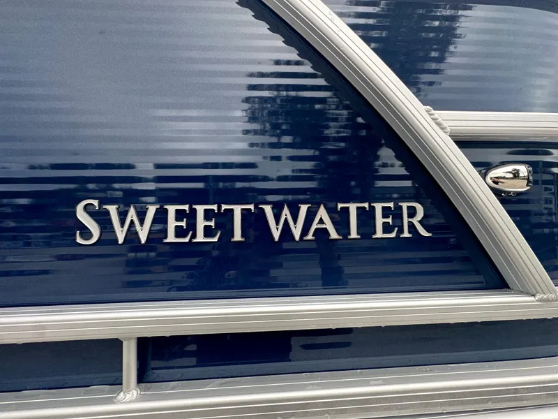 Slide: The Image of 2024 Sweetwater 2286 SB boat, sleek blue exterior with silver accents. - 5