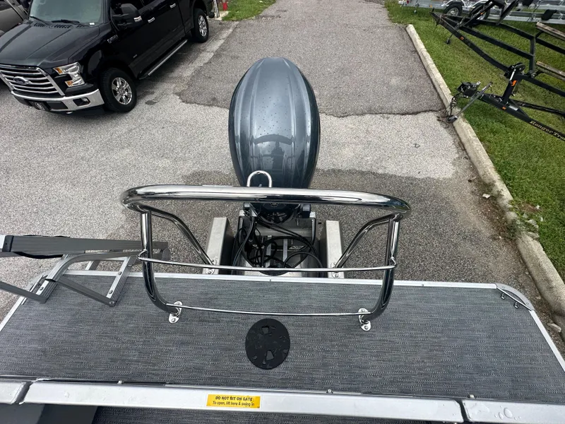 Slide: The Image of 2024 Sweetwater 2286 SB boat with outboard motor, parked on a trailer. - 7