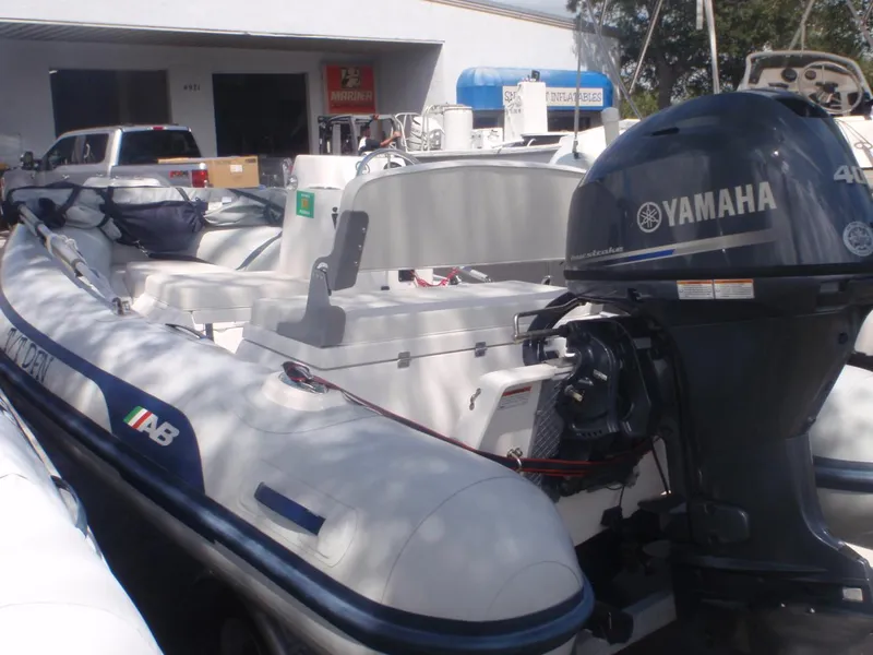 Slide: The Image of 2022 AB Inflatables Mares 11 VSX boat with Yamaha 40HP engine, docked outdoors. - 4